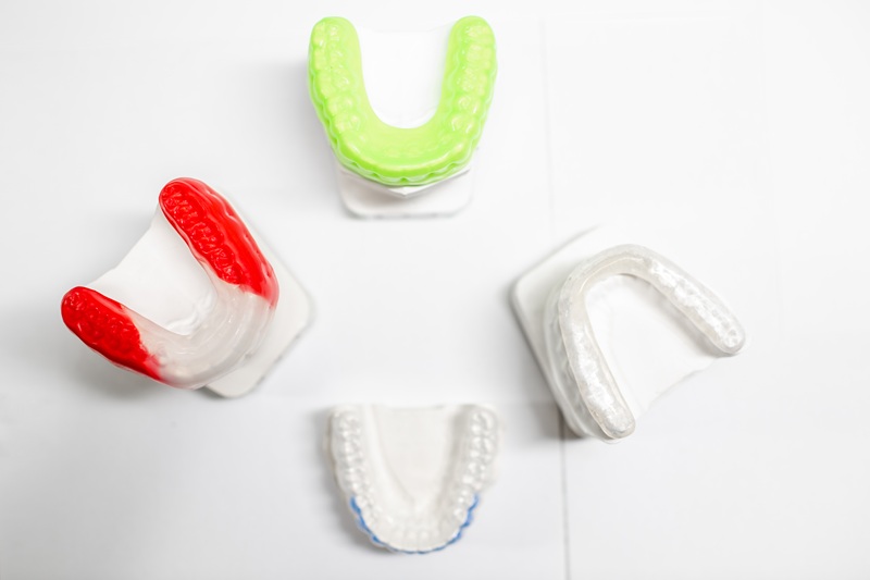 Gypsum models of artificial jaw with dental caps on the white background. Orthodontic caps and boxing caps